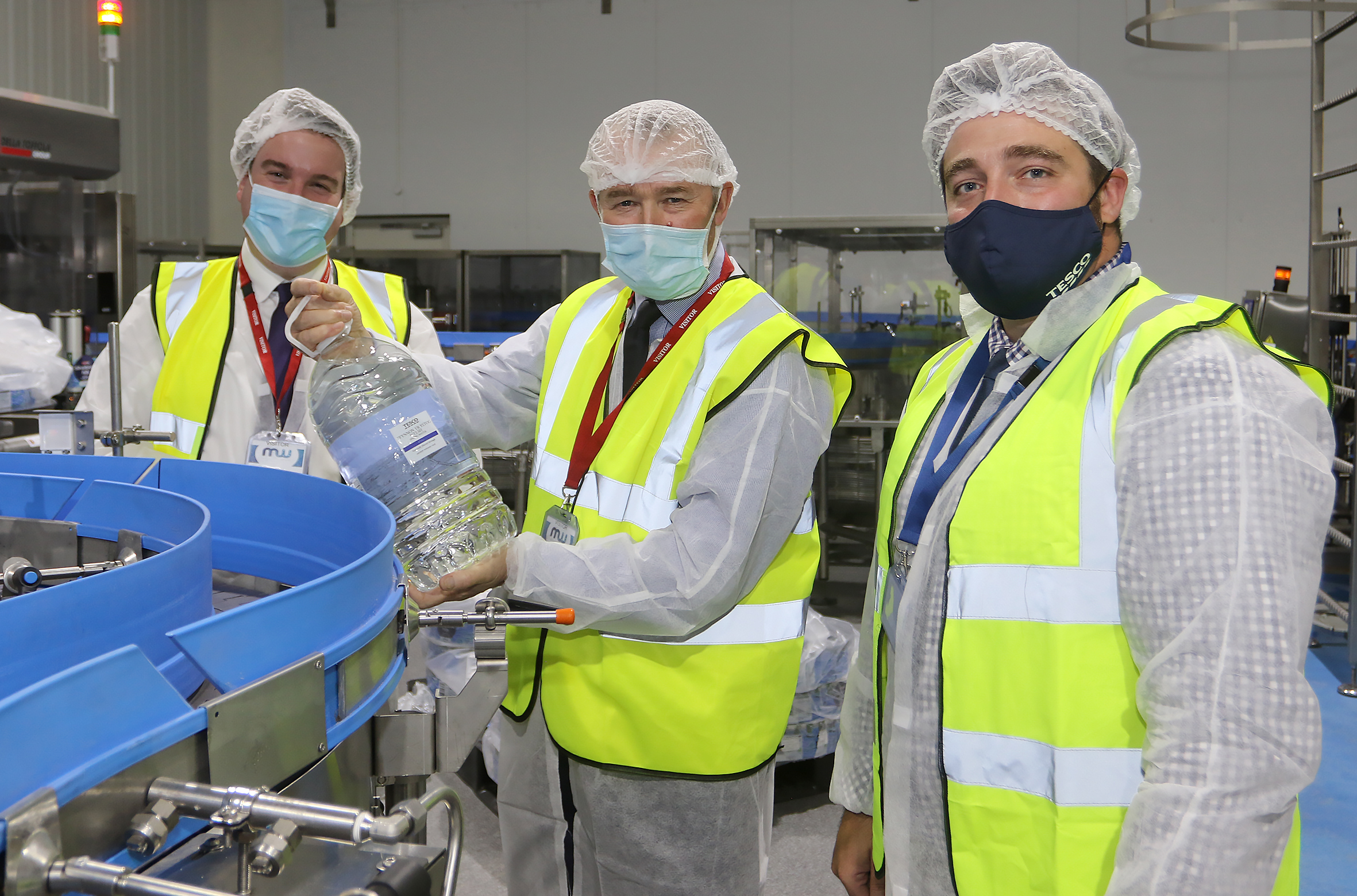 (L-R) Craig Williams MP, Secretary of State for Wales Simon Hart and Nathan Edwards, Local Sourcing Wales Buying Manager for Tesco, at Montgomery Waters in Churchstoke Photo by Phil Blagg Photography