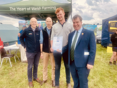 Morgan Tudor receiving his NFU Community Hero award